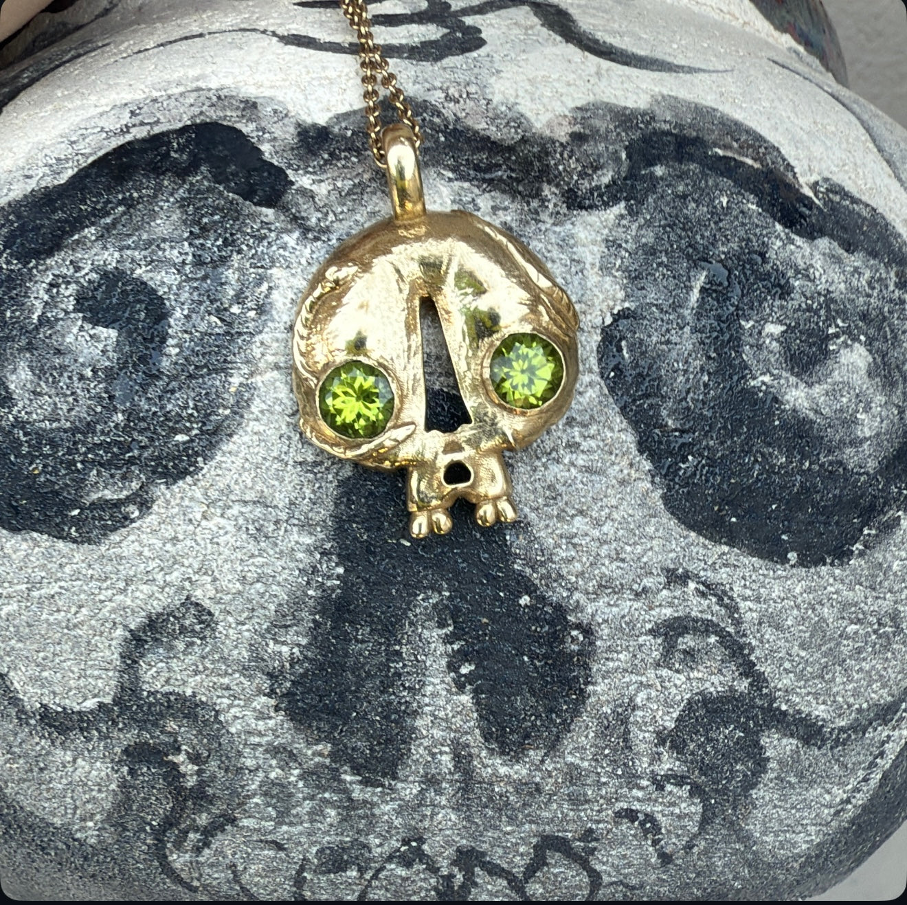 Skull pendant with Peridot eyes, made by Taylor Bosworth