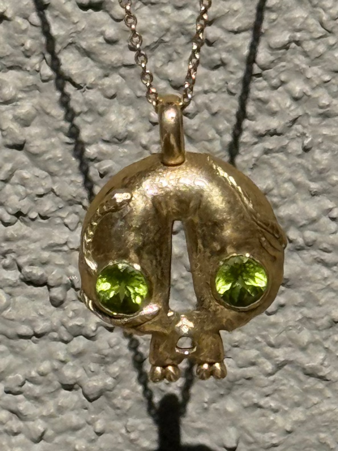 Skull pendant with Peridot eyes, made by Taylor Bosworth
